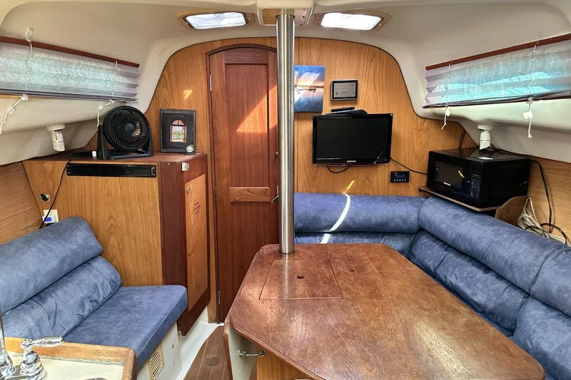 Slide: The Image of Interior of a 2000 Hunter 290 sailboat with cozy seating and modern amenities. - 8