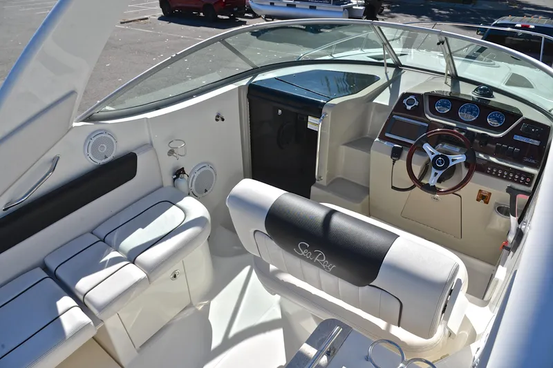 Slide: The Image of 2011 Sea Ray 260 Sundancer boat interior with steering wheel and seating. - 20