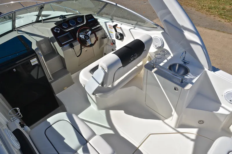 Slide: The Image of Interior of 2011 Sea Ray 260 Sundancer boat with helm, seating, and sink. - 21