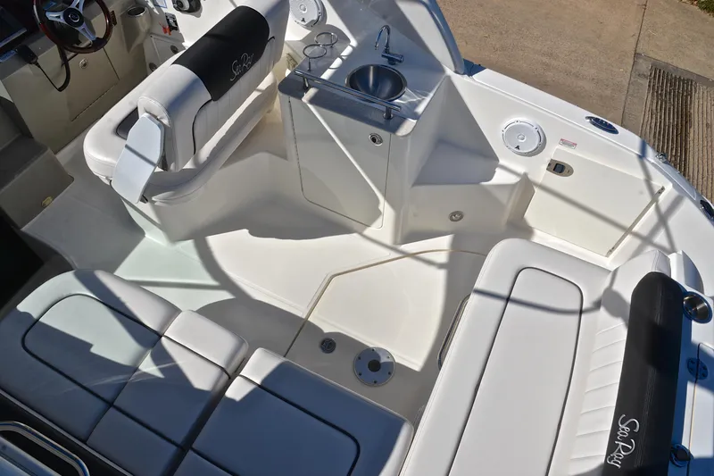 Slide: The Image of 2011 Sea Ray 260 Sundancer boat interior with seating and sink. - 22