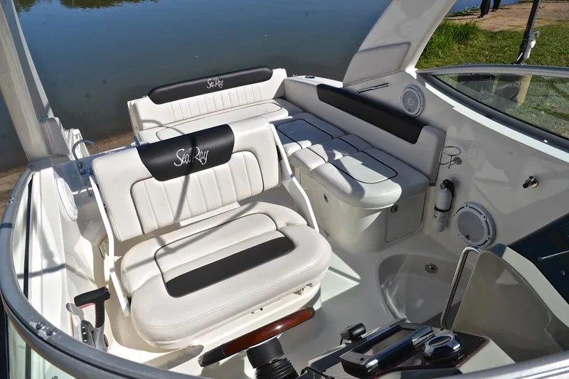 Slide: The Image of Interior of 2011 Sea Ray 260 Sundancer boat with white seating and control panel. - 23