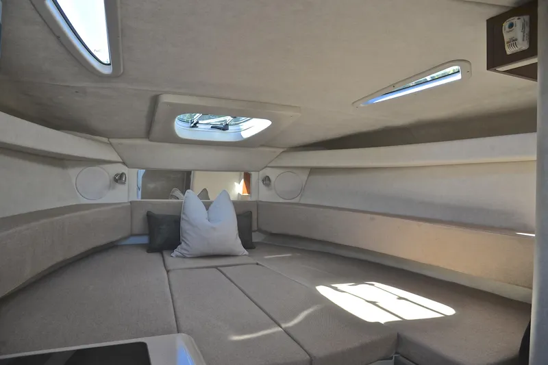 Slide: The Image of Interior cabin of 2011 Sea Ray 260 Sundancer with beige upholstery and skylight. - 31