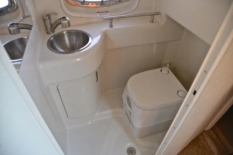 Slide: The Image of Compact bathroom in 2011 Sea Ray 260 Sundancer boat with sink and portable toilet. - 36