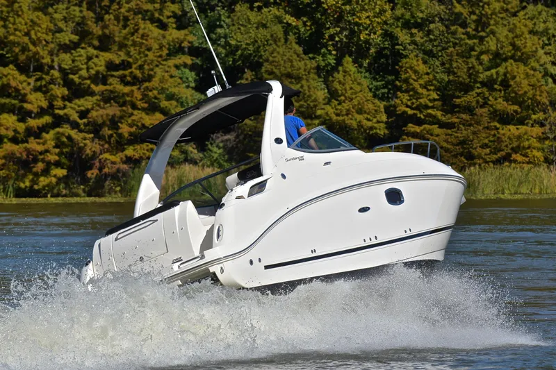 Slide: The Image of 2011 Sea Ray 260 Sundancer cruising on a scenic lake with lush green trees. - 5