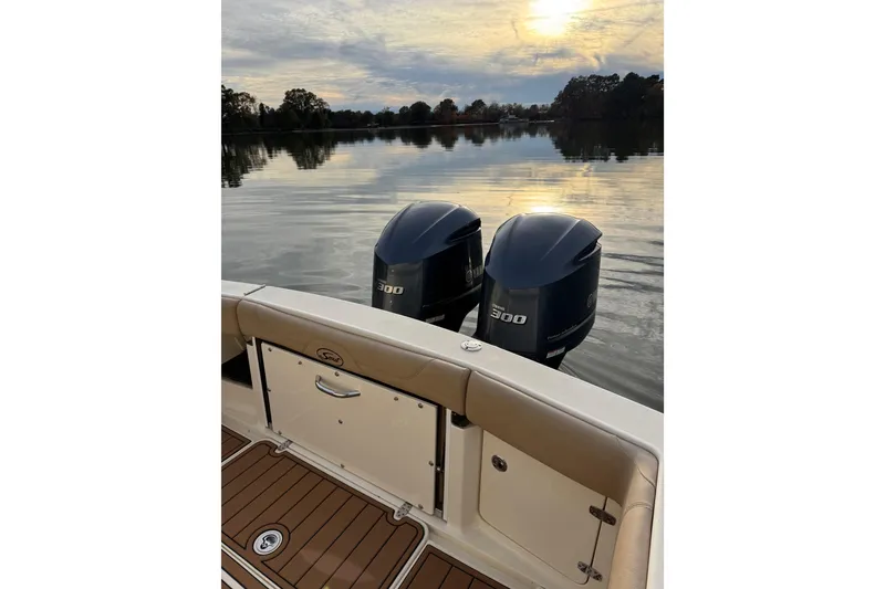 Slide: The Image of 2016 Scout 300 LXF boat with twin Yamaha 300 engines on calm water. - 12