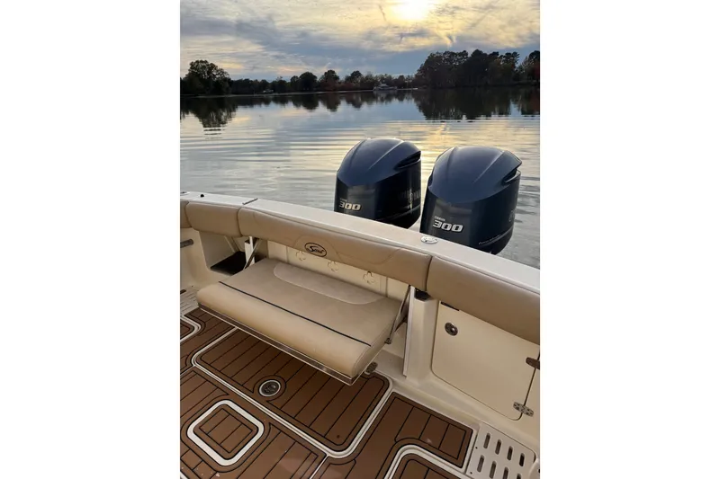 Slide: The Image of 2016 Scout 300 LXF boat interior with helm, navigation screens, and teak flooring. - 13