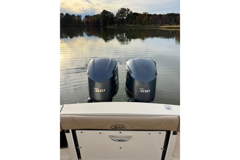 Slide: The Image of Helm of 2016 Scout 300 LXF boat with navigation screens and steering wheel. - 14