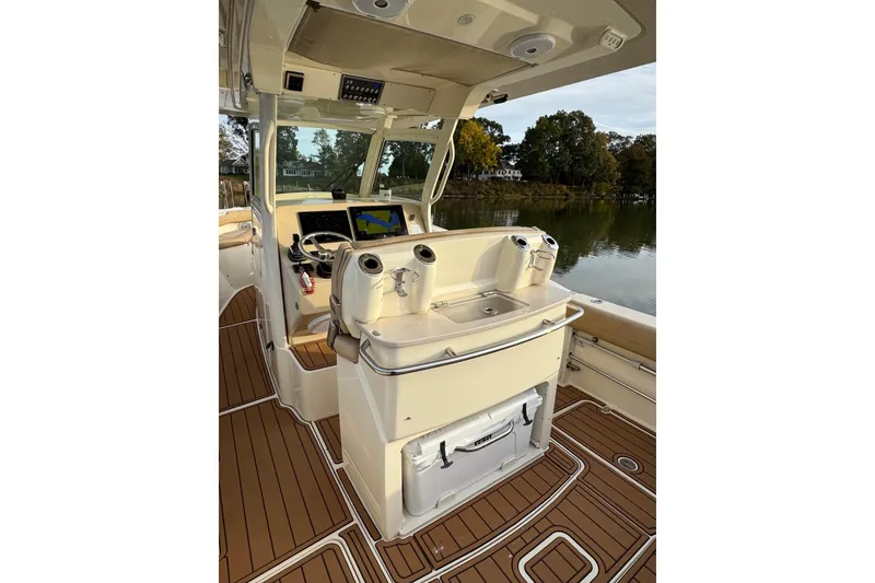 Slide: The Image of 2016 Scout 300 LXF boat helm with advanced navigation displays and controls. - 15