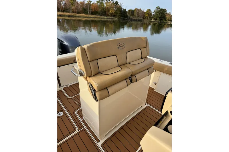 Slide: The Image of 2016 Scout 300 LXF boat interior with teak flooring and steering console. - 18