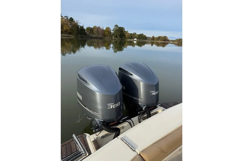 Slide: The Image of 2016 Scout 300 LXF boat with teak deck, docked on calm water. - 23