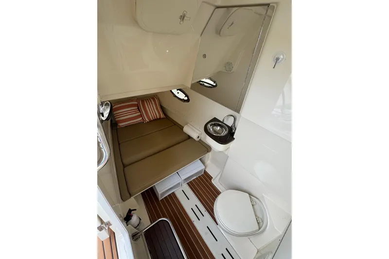 Slide: The Image of 2016 Scout 300 LXF cabin interior with bed, sink, and toilet. - 25