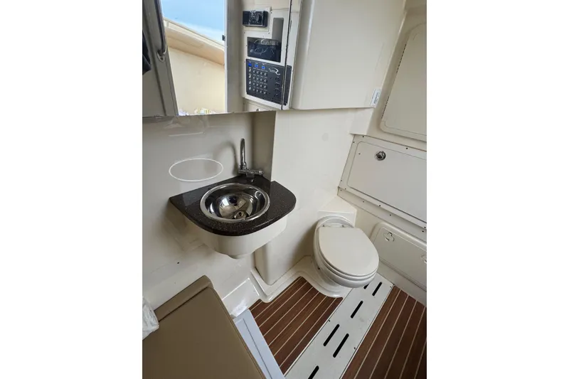 Slide: The Image of 2016 Scout 300 LXF boat bathroom with sink and toilet. - 27