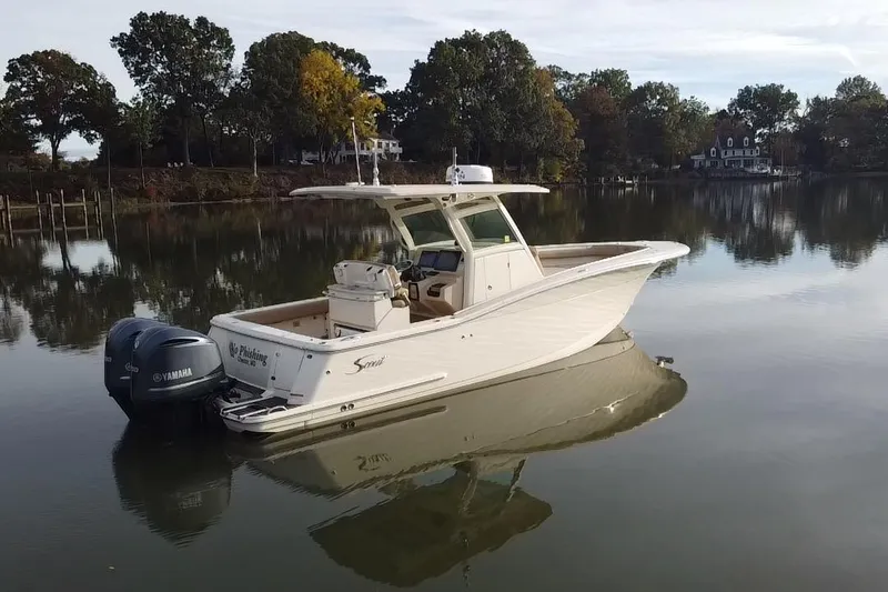 Slide: The Image of 2016 Scout 300 LXF boat with dual Yamaha engines on calm water. - 3