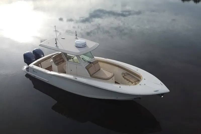 Slide: The Image of 2016 Scout 300 LXF boat with dual Yamaha engines on calm water. - 8