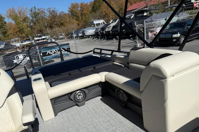 Slide: The Image of 2026 Avalon Venture 85 VRB 2385 pontoon boat interior with beige seating and speaker system. - 11