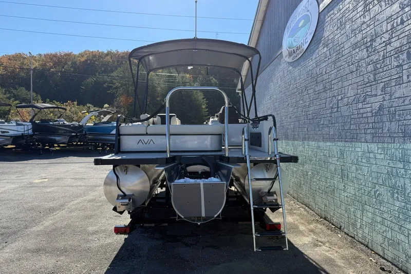 Slide: The Image of 2026 Avalon Venture 85 VRB 2385 pontoon boat parked near a marine shop. - 5