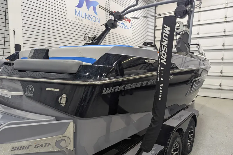 Slide: The Image of 2022 Malibu Wakesetter 22 LSV boat in showroom, featuring sleek design and Surf Gate technology. - 10