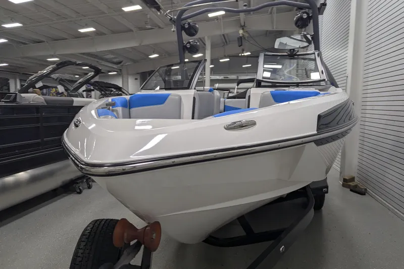 Slide: The Image of 2022 Malibu Wakesetter 22 LSV boat in showroom, featuring sleek design and blue interior. - 15