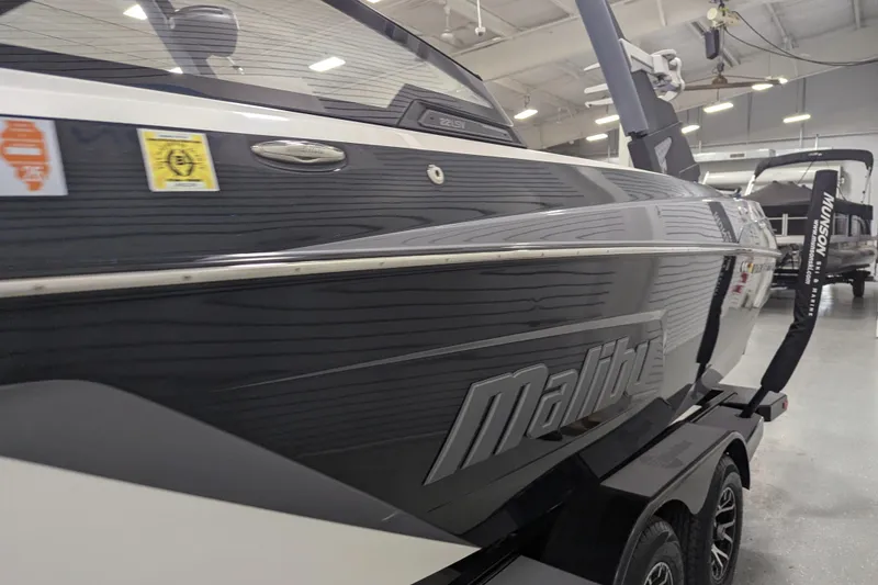 Slide: The Image of 2022 Malibu Wakesetter 22 LSV boat in showroom, side view with trailer. - 18