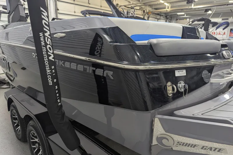 Slide: The Image of 2022 Malibu Wakesetter 22 LSV boat in showroom, featuring sleek design and Surf Gate technology. - 19