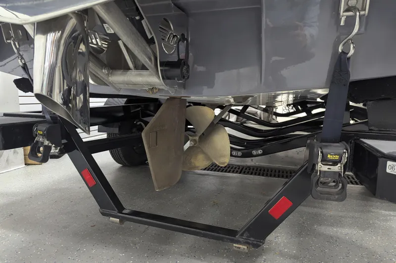Slide: The Image of 2022 Malibu Wakesetter 22 LSV boat propeller and trailer detail in garage. - 21