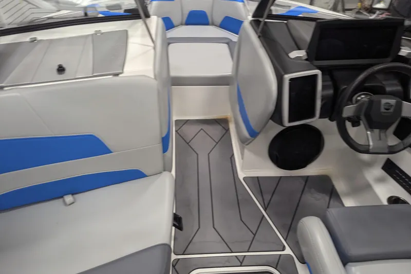 Slide: The Image of 2022 Malibu Wakesetter 22 LSV interior with modern dashboard and blue-gray seating. - 27