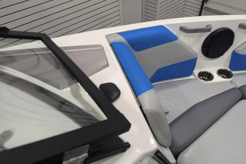 Slide: The Image of 2022 Malibu Wakesetter 22 LSV interior with blue and gray seating, cup holders, and windshield. - 28