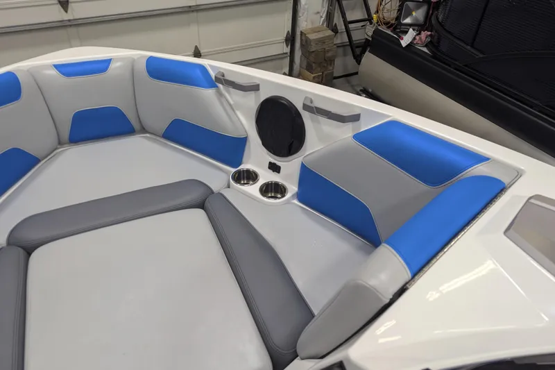 Slide: The Image of 2022 Malibu Wakesetter 22 LSV interior with blue and gray seating, cup holders, and speaker. - 34