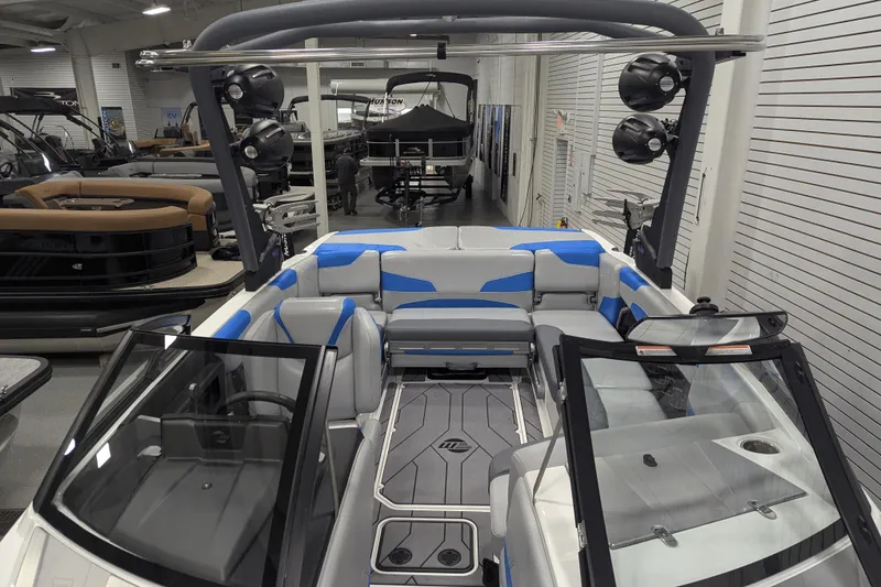 Slide: The Image of 2022 Malibu Wakesetter 22 LSV boat interior with blue and gray seating in showroom. - 37