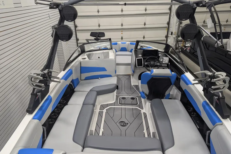 Slide: The Image of 2022 Malibu Wakesetter 22 LSV interior with blue and gray seating in a garage. - 38