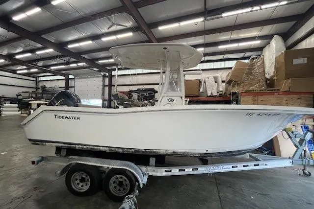 The Image of 2021 Tidewater 220 CC Adventure boat on trailer in warehouse setting. - 0