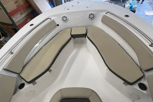 Slide: The Image of 2021 Tidewater 220 CC Adventure boat interior with cushioned seating and speakers. - 10