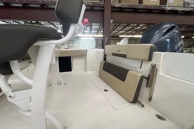 Slide: The Image of 2021 Tidewater 220 CC Adventure boat interior with seating and engine view. - 11