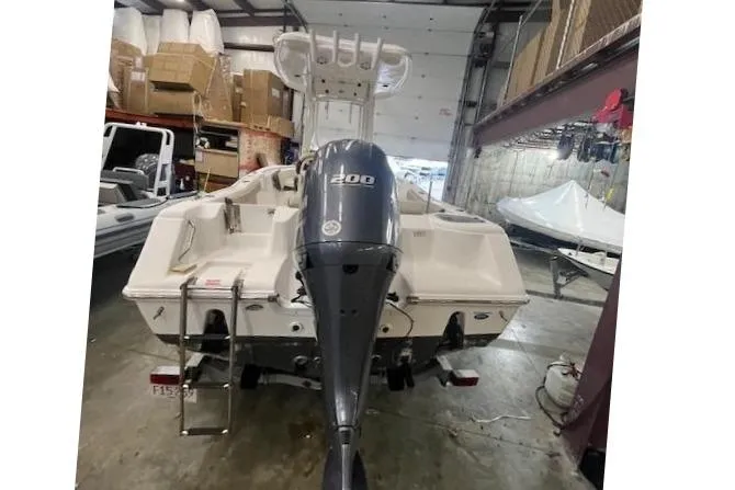 Slide: The Image of 2021 Tidewater 220 CC Adventure boat with 200 HP engine in storage facility. - 12