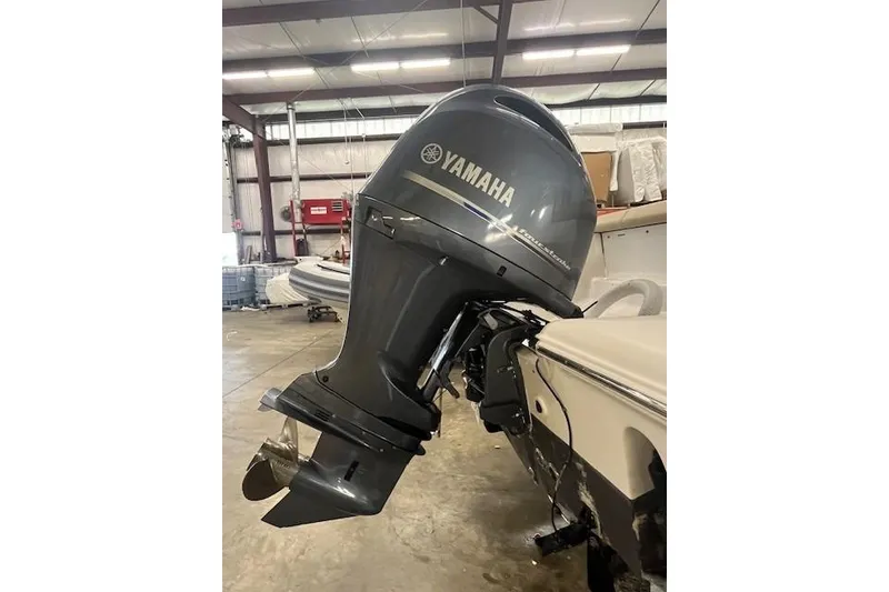 Slide: The Image of 2021 Tidewater 220 CC Adventure with Yamaha outboard motor in a storage facility. - 14