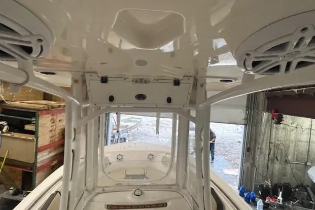 Slide: The Image of 2021 Tidewater 220 CC Adventure boat interior with speakers and storage compartments. - 15