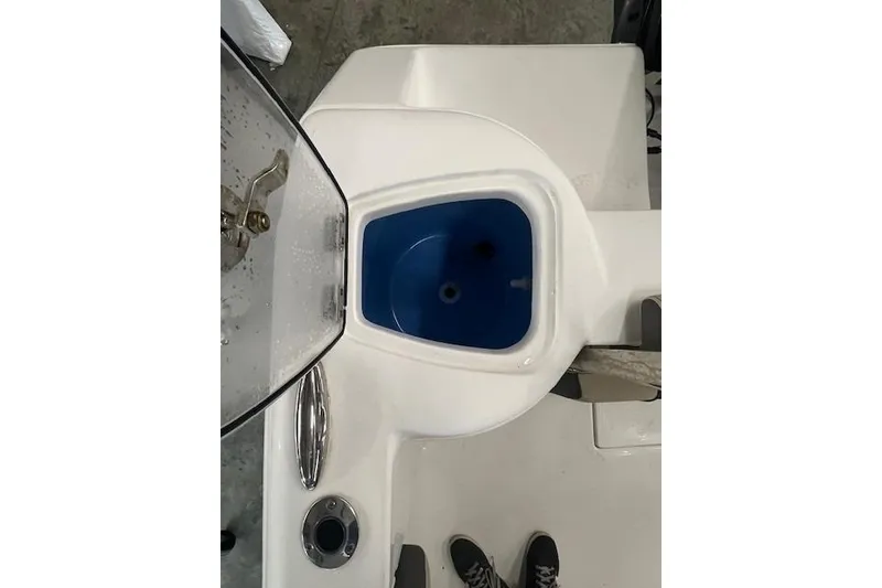 Slide: The Image of 2021 Tidewater 220 CC Adventure boat livewell with open lid, showcasing interior design. - 16