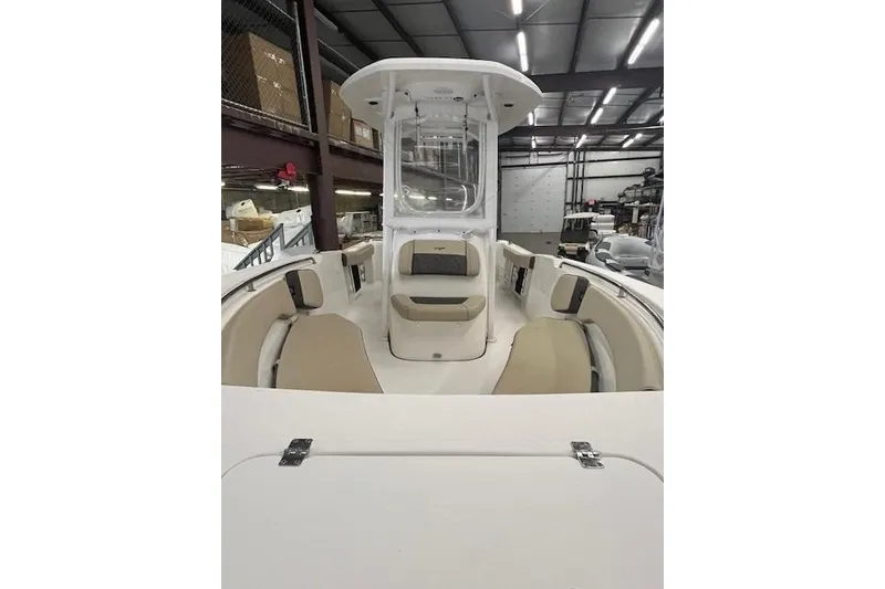 Slide: The Image of 2021 Tidewater 220 CC Adventure boat interior with seating, stored indoors. - 17