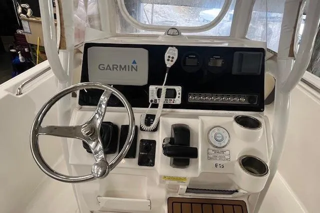 Slide: The Image of 2021 Tidewater 220 CC Adventure boat console with Garmin navigation system and steering wheel. - 2