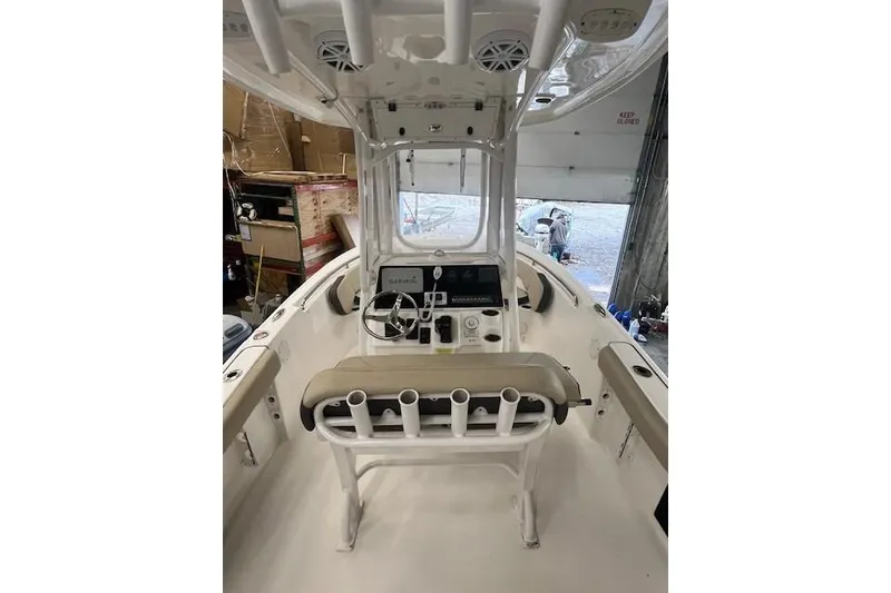 Slide: The Image of 2021 Tidewater 220 CC Adventure boat interior with helm and seating. - 3