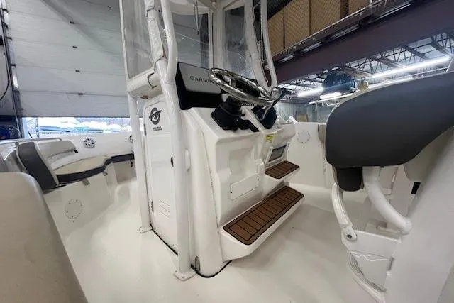 Slide: The Image of 2021 Tidewater 220 CC Adventure boat interior with steering console and seating. - 8