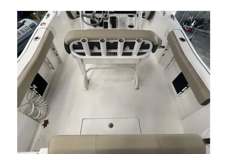 Slide: The Image of 2021 Tidewater 220 CC Adventure boat interior with rod holders and seating. - 9
