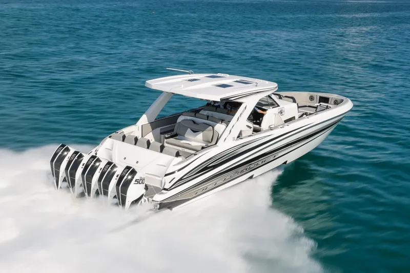 Slide: The Image of 2026 Deep Impact 449 Sport boat cruising near a lighthouse on a sunny day. - 1