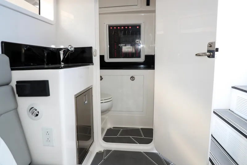 Slide: The Image of Interior of 2026 Deep Impact 449 Sport boat, featuring sleek storage compartments. - 17