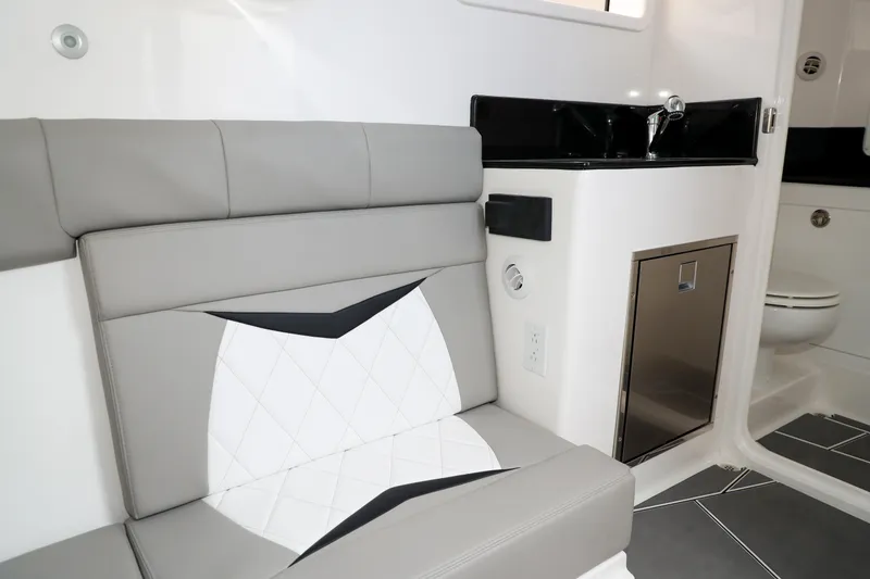 Slide: The Image of Interior of 2026 Deep Impact 449 Sport boat with seating, sink, and modern design. - 18