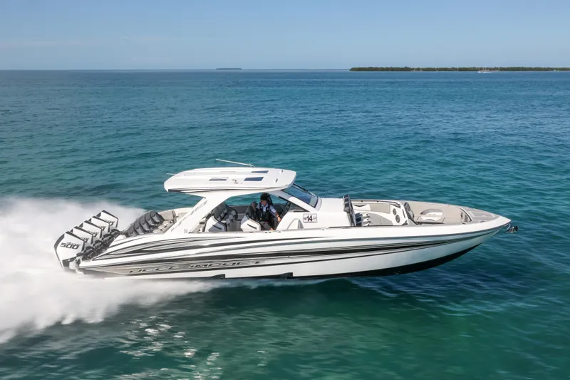 Slide: The Image of 2026 Deep Impact 449 Sport boat cruising near a lighthouse and palm trees. - 3