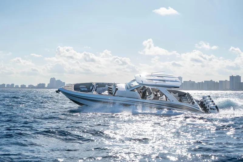 Slide: The Image of Four powerful outboard engines on a 2026 Deep Impact 449 Sport boat, ocean backdrop. - 33