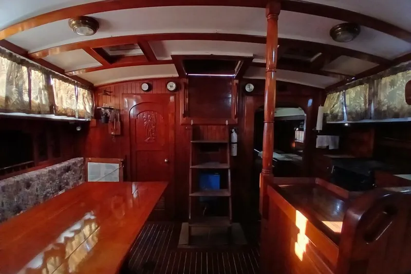 Slide: The Image of Interior of a 1980 Hardin 45 sailboat with wooden furnishings and cozy decor. - 10