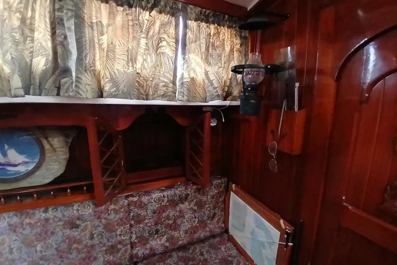Slide: The Image of Interior of a 1980 Hardin 45 sailboat with wood paneling and floral upholstery. - 14