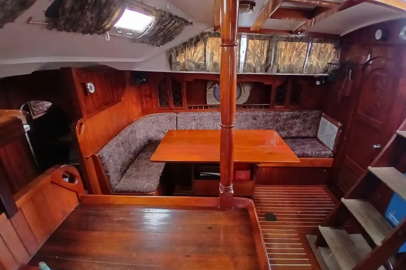Slide: The Image of Interior of 1980 Hardin 45 sailboat with wooden furnishings and cozy seating area. - 16